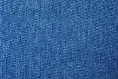 Texture of blue jeans as background, closeup