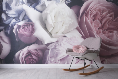 Comfortable rocking-chair near wall with floral wallpaper, space for text. Stylish living room interior