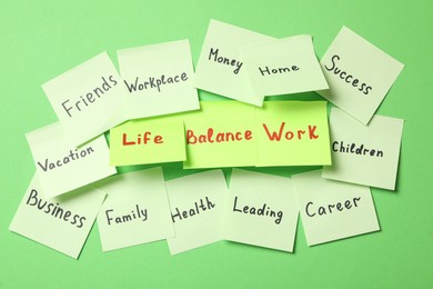 Sticky notes with words on green background. Life and work balance concept