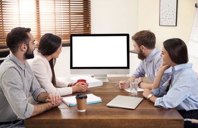 Group of colleagues using video chat on computer in office. Space for text