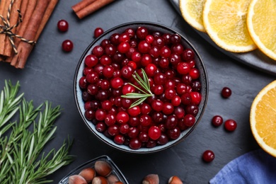 Flat lay composition with fresh ripe cranberries on dark grey table