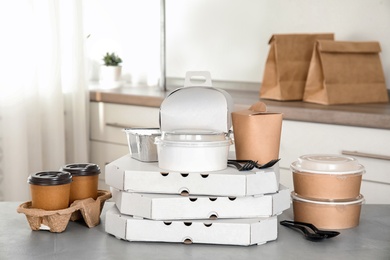 Various takeout containers on table in kitchen. Food delivery service