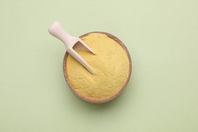 Photo of Beer yeast powder on light green background, top view