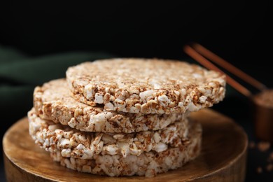 Stack of crunchy buckwheat cakes on wooden plate, closeup