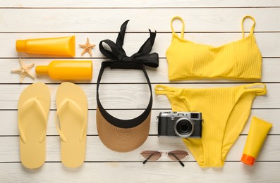 Flat lay composition with beach objects on white wooden background