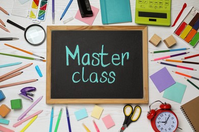 Blackboard with words Master Class surrounded by different stationery on white wooden table, flat lay