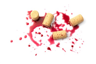 Bottle corks with wine stains on white background, top view