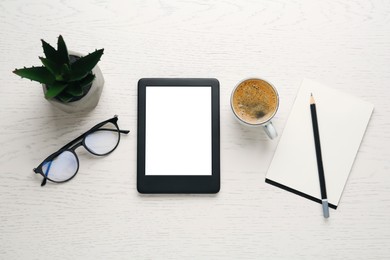 Flat lay composition with modern e-book reader on white wooden table