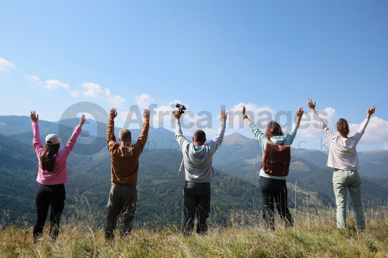 Photo of Group of people spending time together in mountains, back view