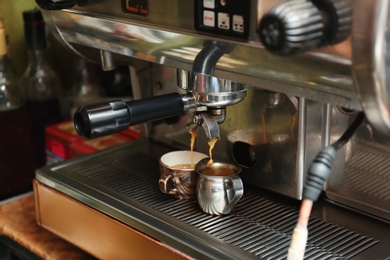 Photo of Preparing fresh aromatic coffee using modern machine at cafe