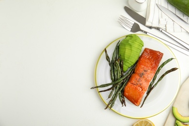 Photo of Tasty cooked salmon and vegetables served on white table, flat lay with space for text. Healthy meals from air fryer