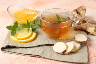 Photo of Tea with mint, honey, lemon and ginger on table