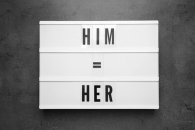 Gender equality. Lightbox with equal sign, words Him and Her on grey table, top view