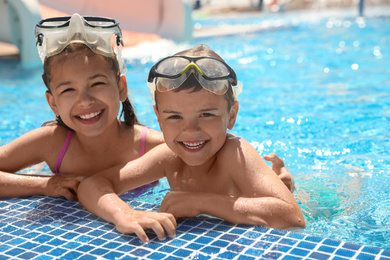 Little children wearing diving mask in swimming pool. Summer vacation