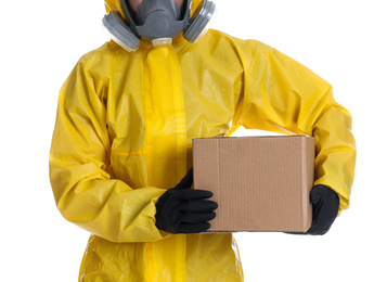 Man wearing chemical protective suit with cardboard box on white background, closeup. Prevention of virus spread