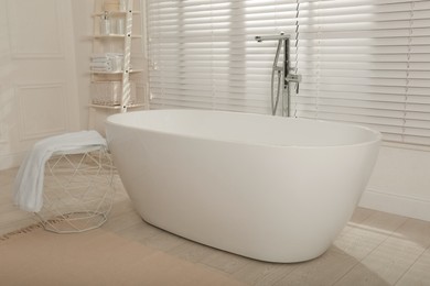 Minimal bathroom interior with modern white tub