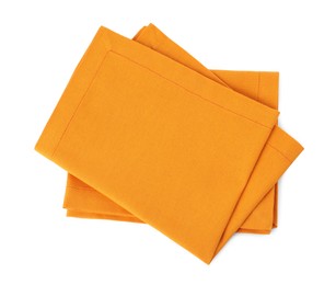 New clean orange cloth napkins isolated on white, top view