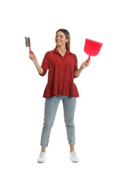 Young woman with broom and dustpan on white background