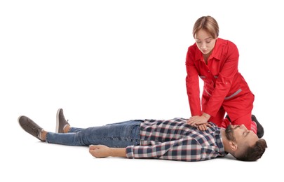 Paramedic in uniform performing first aid on unconscious man against white background