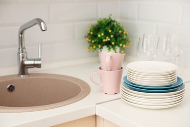 Clean dishes on counter near kitchen sink indoors