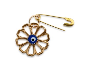 Evil eye safety pin on white background, top view