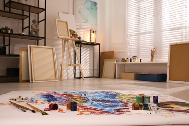 Wooden easel and abstract picture in art studio