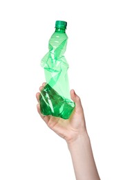 Woman holding crumpled plastic bottle on white background, closeup