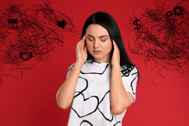 Stressed young woman with mess in her head on red background