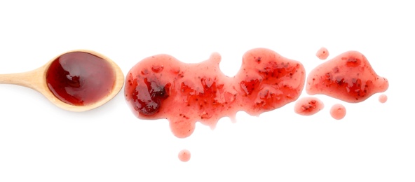 Spoon and sweet berry jam on white background