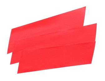 Photo of Pieces of red insulating tape isolated on white, top view