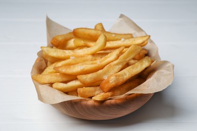 Photo of Bowl of french fries on white wooden table