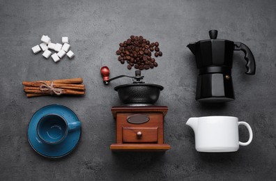 Photo of Flat lay composition with vintage manual grinder and geyser coffee maker on black table