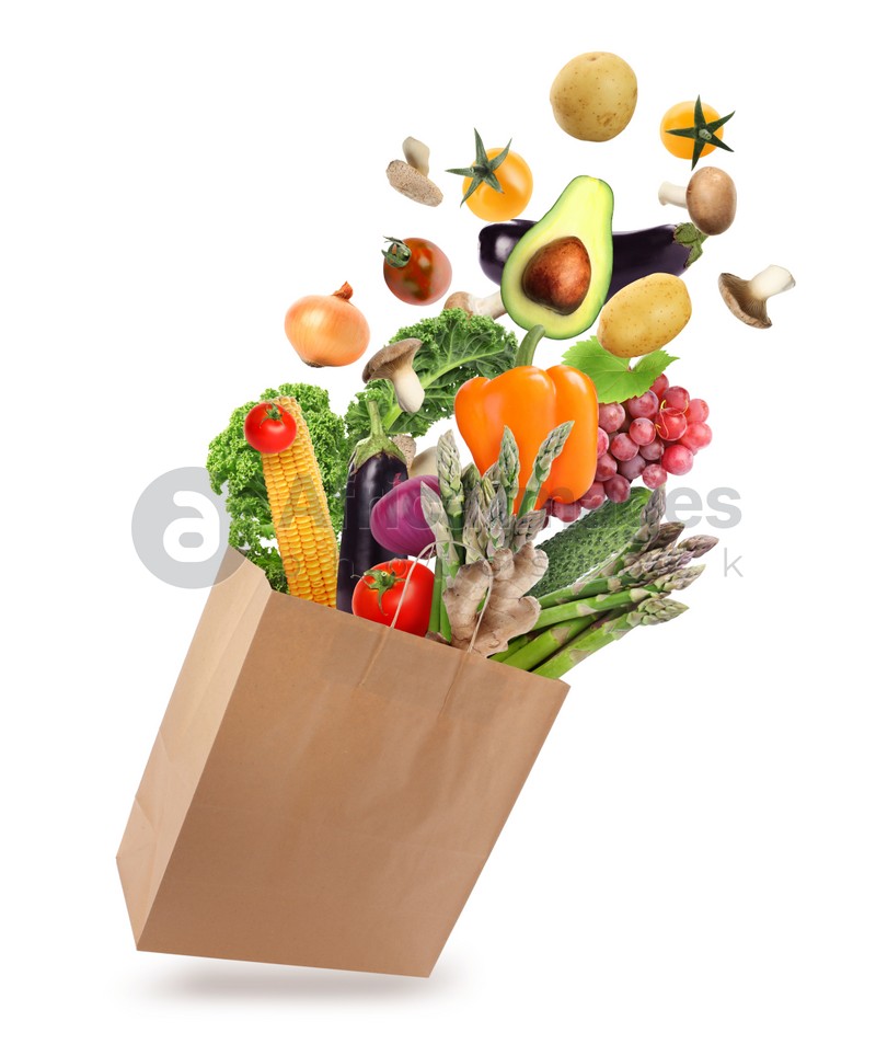 Image of Paper bag with vegetables and fruits on white background. Vegetarian food 