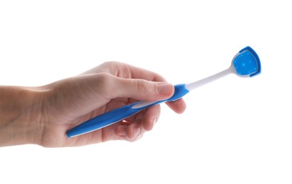 Woman holding tongue cleaner for oral care on white background, closeup