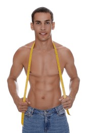 Handsome shirtless man with slim body and measuring tape isolated on white