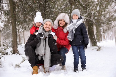 Portrait of happy family outside on winter day. Christmas vacation
