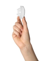 Woman holding anti-snoring device for nose on white background, closeup
