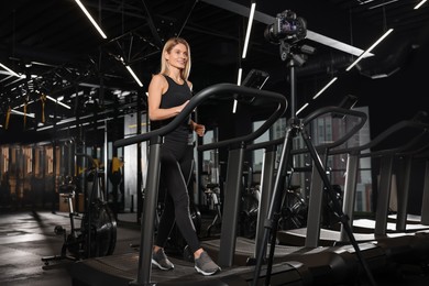 Photo of Fitness trainer recording online classes in gym