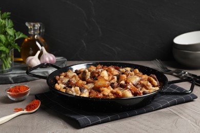 Photo of Tasty fried cracklings on grey table. Cooked pork lard