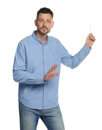 Handsome man pointing at something with pen on white background. Weather forecast reporter