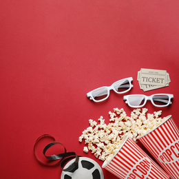 Flat lay composition with delicious popcorn on red background