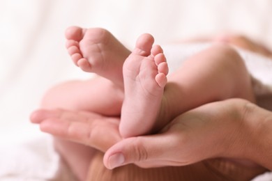 Mother and her newborn baby on bed, closeup view