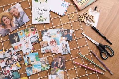 Flat lay composition with different photos, stationery and metal grid on wooden background. Creating vision board