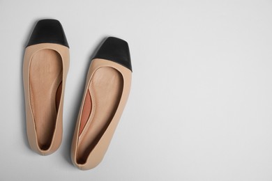 Photo of Pair of new stylish square toe ballet flats on light grey background, flat lay. Space for text
