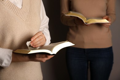 Women reading Bibles together, closeup. Religious literature