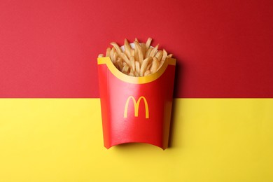 MYKOLAIV, UKRAINE - AUGUST 12, 2021: Big portion of McDonald's French fries on color background, top view