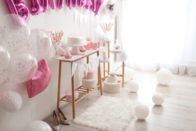 Room decorated with balloons for birthday party