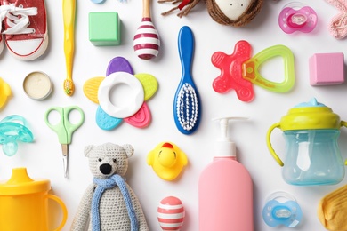 Flat lay composition with baby accessories on white background