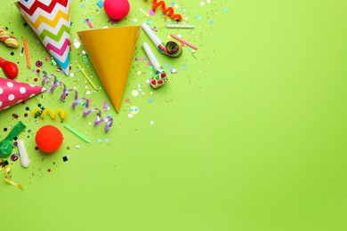 Beautiful flat lay composition with festive items on light green background, space for text. Surprise party concept