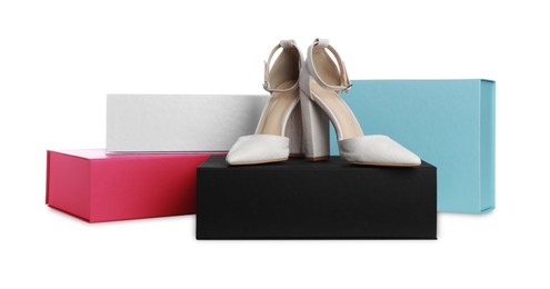 Pair of stylish shoes and boxes on white background